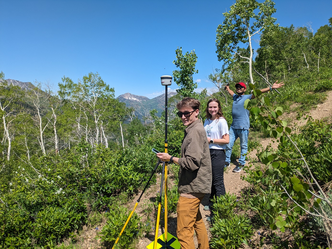 Students with GIS equipment on a mountain